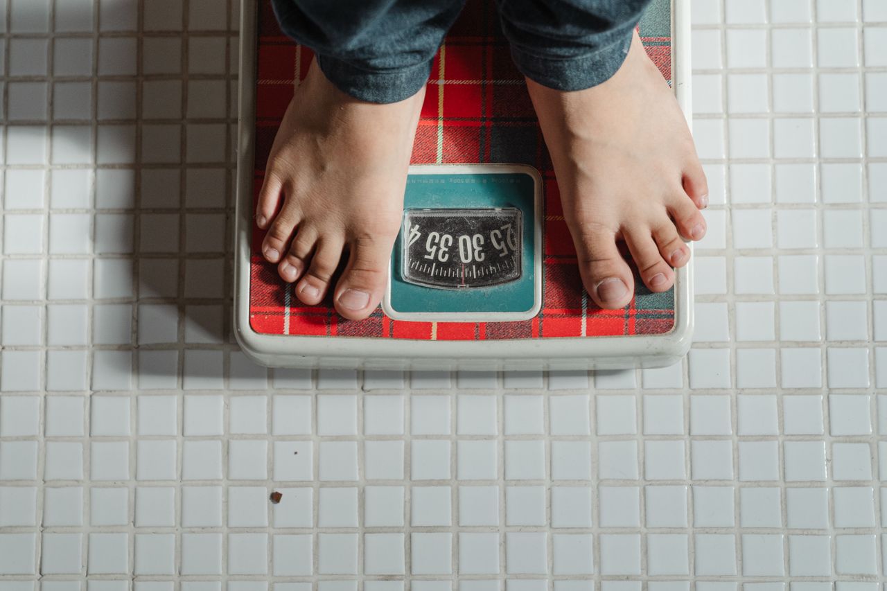 The Art of Drawing Readers In: Your attractive post title goes here From above crop anonymous barefoot child in jeans standing on weigh scales on tiled floor of bathroom